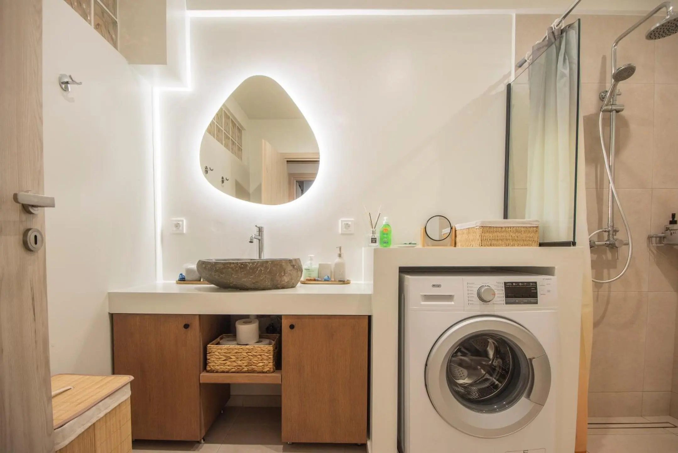Bathroom featuring walk-in shower and washing machine